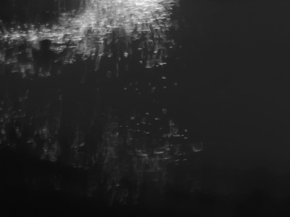 close up of some sparks reflected in water and converted to black and white